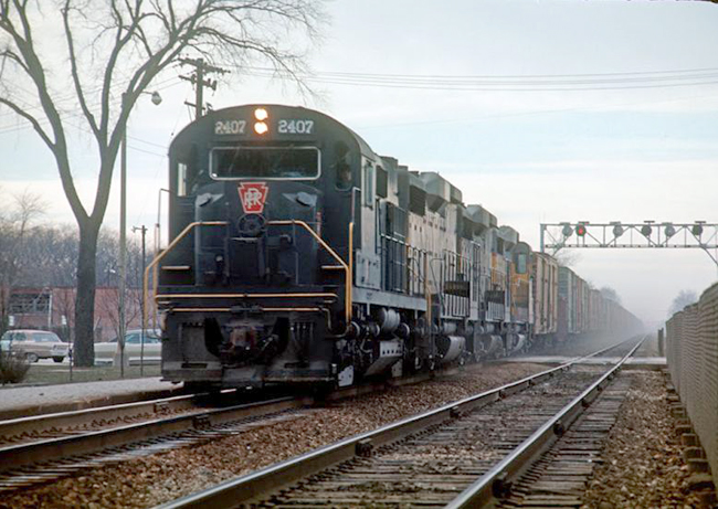 Taken by an unknown photographer, this shot shows eastbound CB&Q hotshot GI-68 on the triple-track main through the western Chicago suburbs at La Grange, IL, in January 1968.    GI-67 and 68 were CB&Q/UP pool trains between Chicago and North Platte, NE, interchanged at Grand Island, NE (hence the  "GI" symbol).  As the lead RS-27 (PRR class AF-24) illustrates, this run-through operation also involved the PRR east of Chicago.  The traffic from GI-68 will go east on PRR symbols AC-2/4 and AST-4, with the foreign power turning at either Conway or Enola, PA.  Submitted by Fred Ripley.