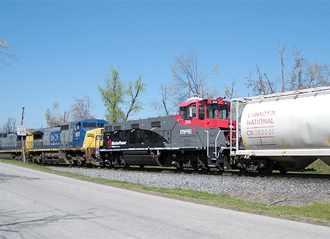 Right: Another beautiful Spring day set the stage for this shot at Morton’s Gap, KY, as this north-bound CSX freight slides off to the right onto the Cut-off main around Madisonville.  In the consist is a new environmentally friendly GenSet locomotive. Matt Gentry took this photo  from Ricky Bivin’s  driveway. 