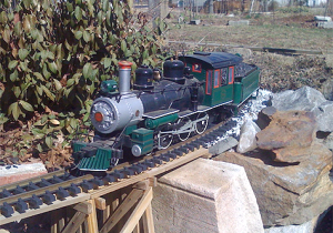 ET&WNC Ten-Wheeler, No. 12, makes the tight curve over Liam’s Creek, on Bill Thomas’ outdoor Hook Line & Singer Railway.