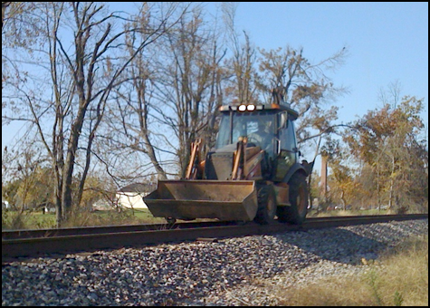Certainly not the greatest fall shot I’ve ever taken, but interesting enough to make me chase it down the Morganfield Branch to get a shot of it behind People Plus on 41A, just west of Madisonville.  For quick shots in a pinch, the i-phone does ok.  This is simply a front-end-loader with small rail wheels attached to the bucket’s bottom.  The rear tires seemed to have no guidance devices other than possibly being a little under-inflated to keep them centered on the rails.  Not sure.  -Bill Thomas