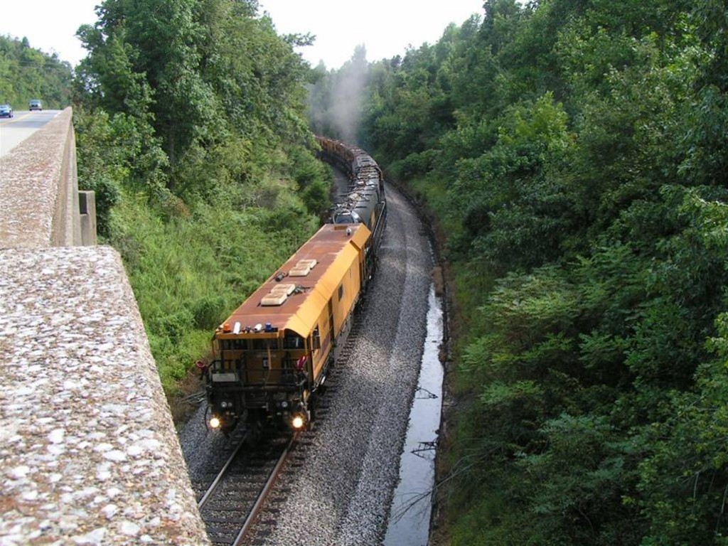 Rick Bivens catchers the Loram Rail Grinder working north under the  Hwy 41 bridge at Morton’s  Gap, KY, August 20, 2011.