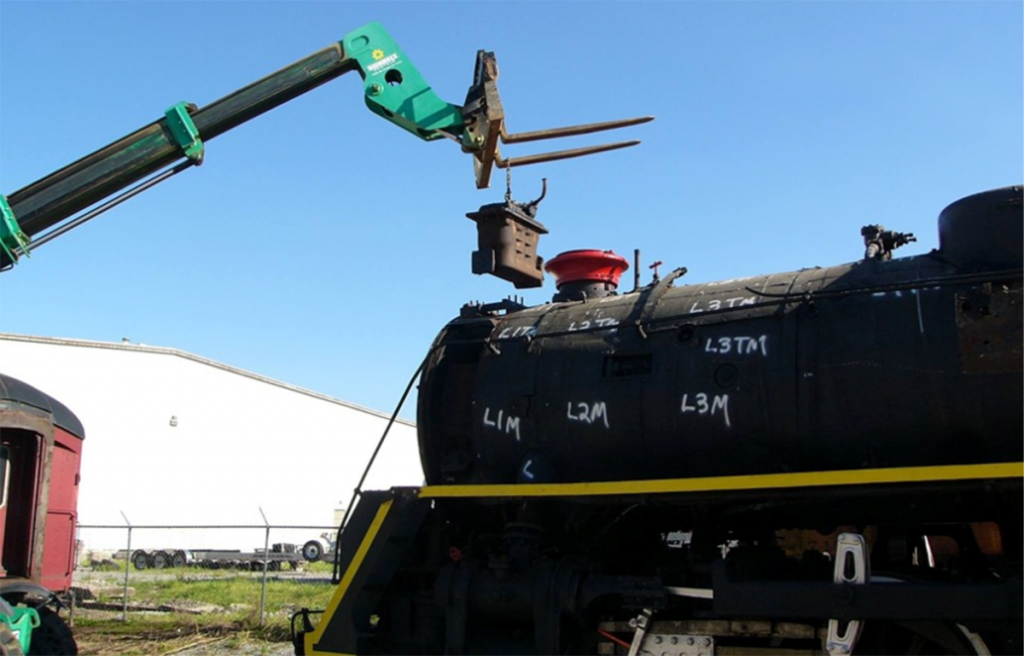 July 2 - The feed water heater is carefully removed from the top of the smoke box.